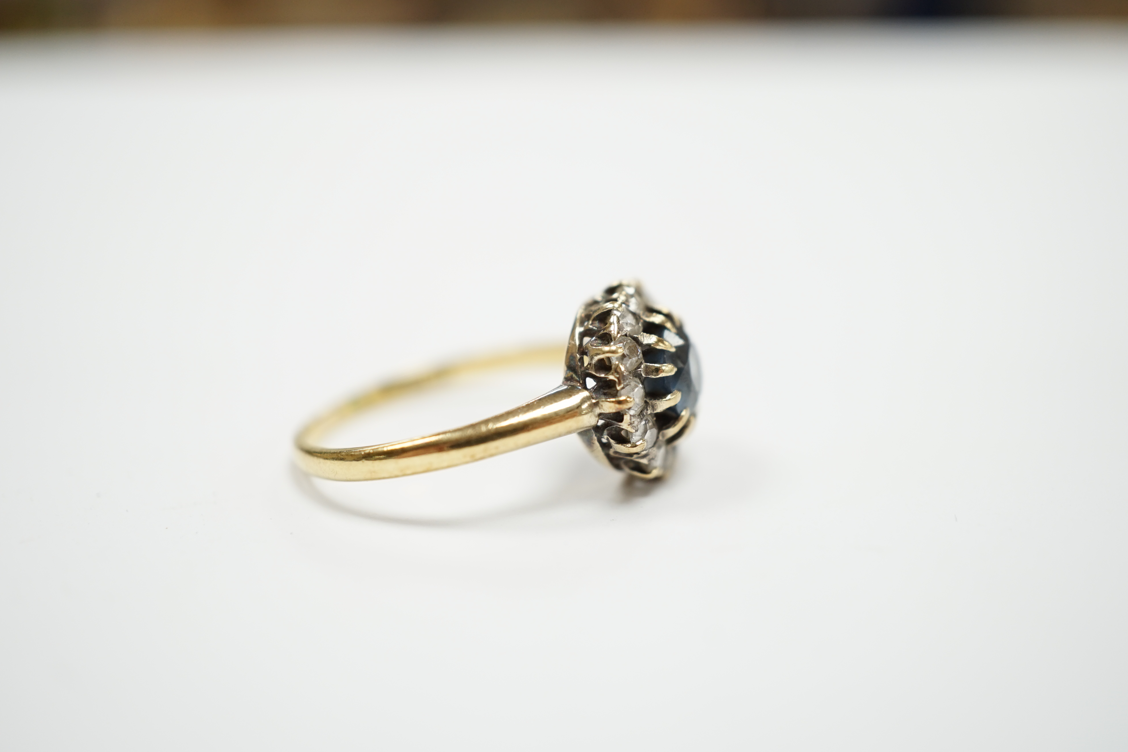 An early 20th century 18ct, sapphire and diamond set circular cluster ring, size P, gross weight 3.3 grams.